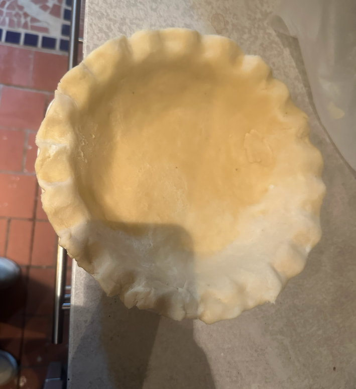 Pie dough in a pie pan.
