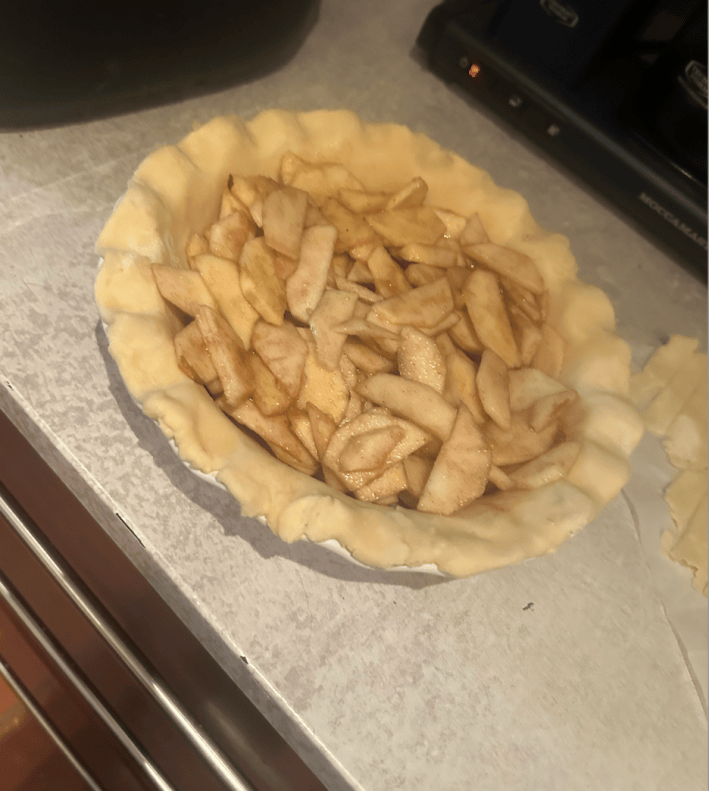 bunch of uncooked apples inside pie dough