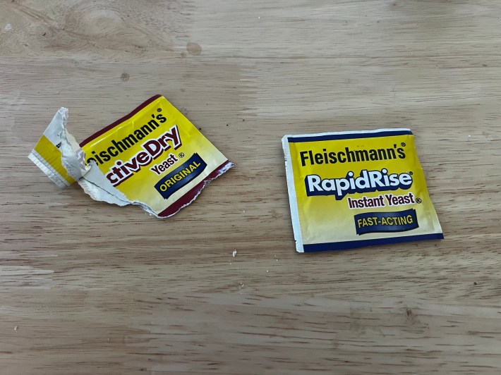 Two baggies of yeast. The one marked "original" is opened and used, the one marked "fast-acting" is unopened.